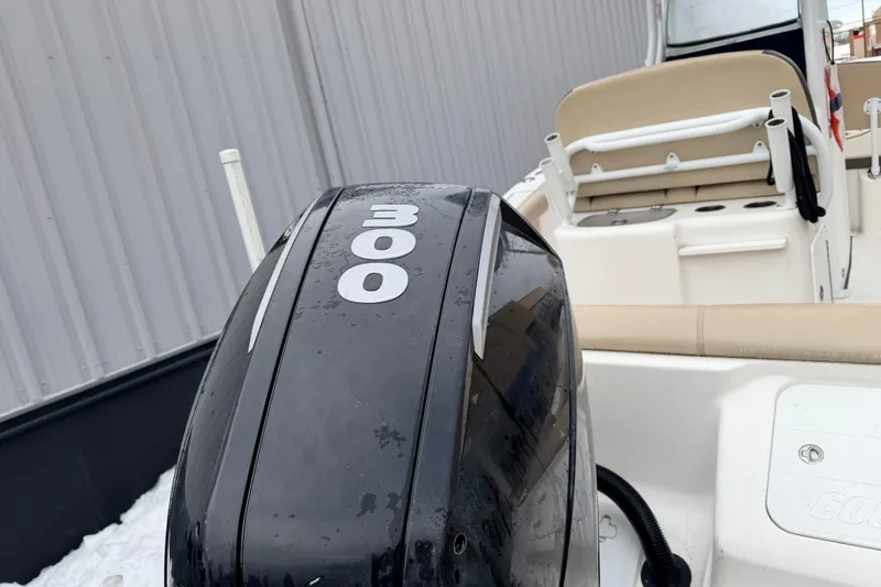 Slide: The Image of 2018 Tidewater 232 SS boat with a 300 horsepower engine, docked near a metal wall. - 8