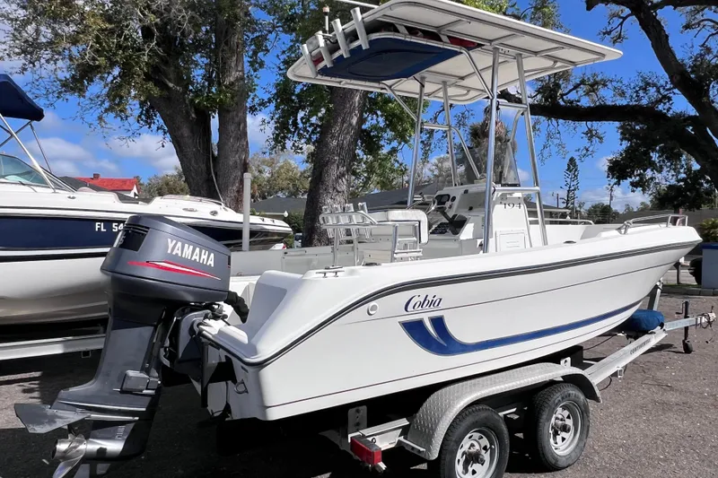The Image of 2001 Cobia 194 Center Console boat with Yamaha outboard motor on trailer. - 0