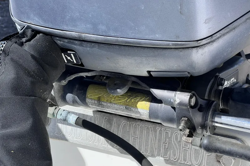 Slide: The Image of Close-up of a 2001 Cobia 194 Center Console outboard hydraulic steering system. - 11