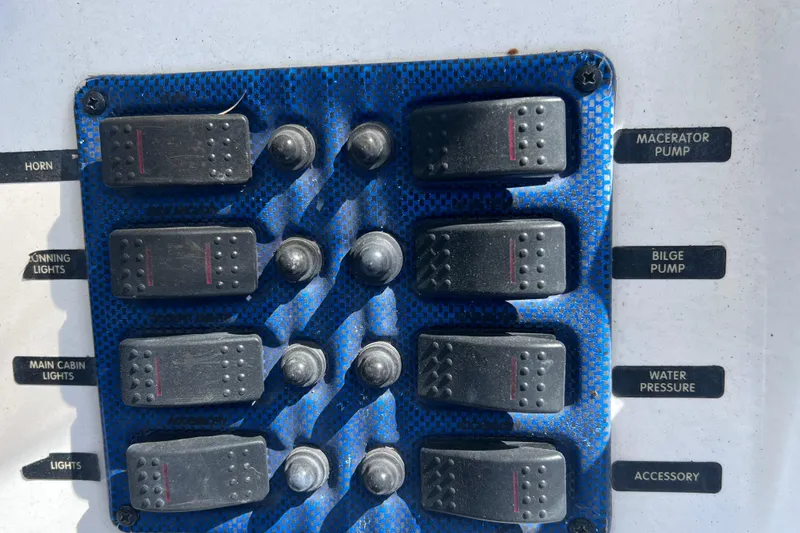 Slide: The Image of Control panel of a 2001 Cobia 194 Center Console boat with labeled switches. - 13