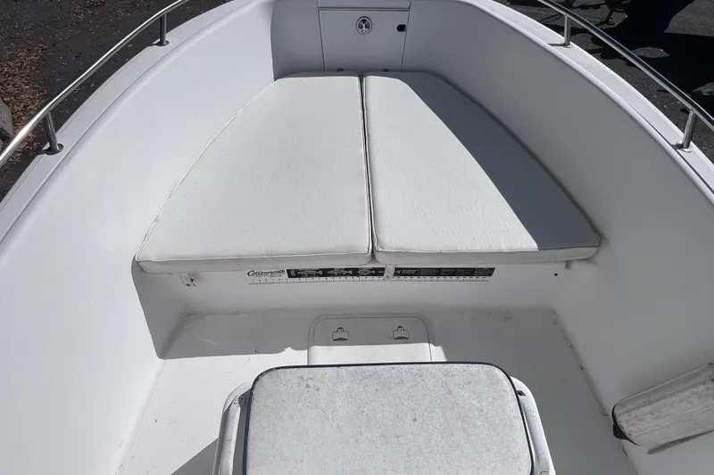 Slide: The Image of 2001 Cobia 194 Center Console boat interior with cushioned seating and stainless steel railings. - 14
