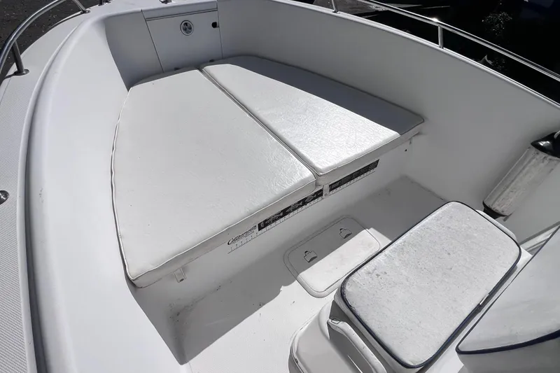Slide: The Image of 2001 Cobia 194 Center Console boat interior with cushioned seating and storage compartments. - 15