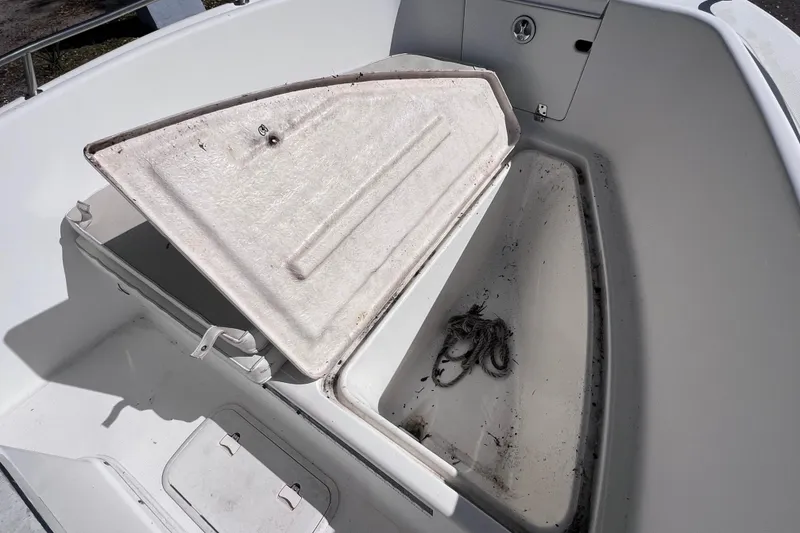 Slide: The Image of Open storage compartment on a 2001 Cobia 194 Center Console boat. - 16