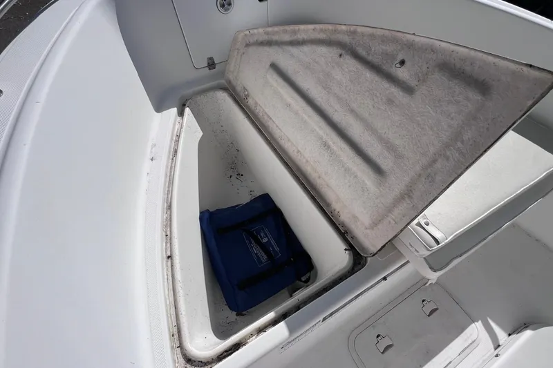 Slide: The Image of Open storage compartment on 2001 Cobia 194 Center Console boat with blue bag inside. - 17