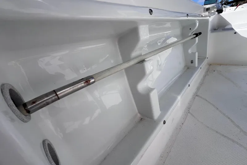 Slide: The Image of 2001 Cobia 194 Center Console boat interior with rod holder detail. - 20