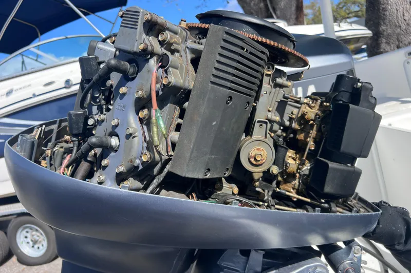 Slide: The Image of Close-up of a 2001 Cobia 194 Center Console boat engine, showcasing intricate mechanical details. - 24