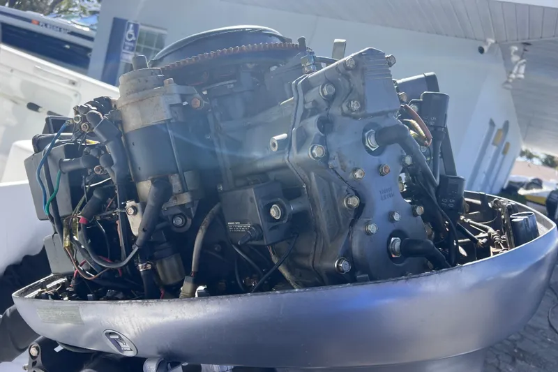 Slide: The Image of Close-up of a 2001 Cobia 194 Center Console boat engine, showcasing intricate mechanical details. - 25