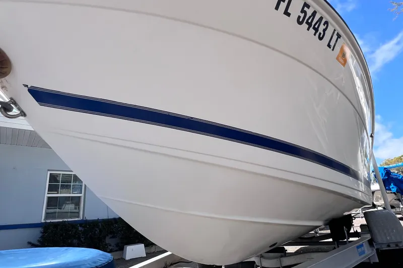 Slide: The Image of 2001 Cobia 194 Center Console boat on trailer, side view with registration number visible. - 5