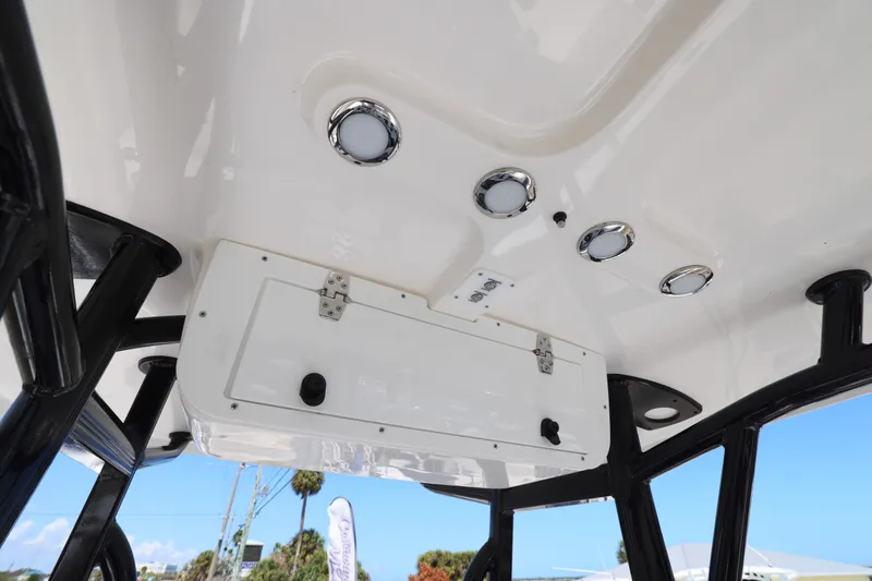 Slide: The Image of Interior view of 2026 Sea Hunt Ultra 219 boat's ceiling with lights and storage. - 10