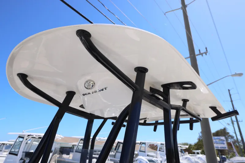 Slide: The Image of 2026 Sea Hunt Ultra 219 boat T-top against clear blue sky. - 13