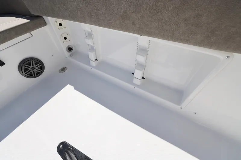 Slide: The Image of Interior view of 2026 Sea Hunt Ultra 219 boat, featuring speaker and storage compartment. - 16