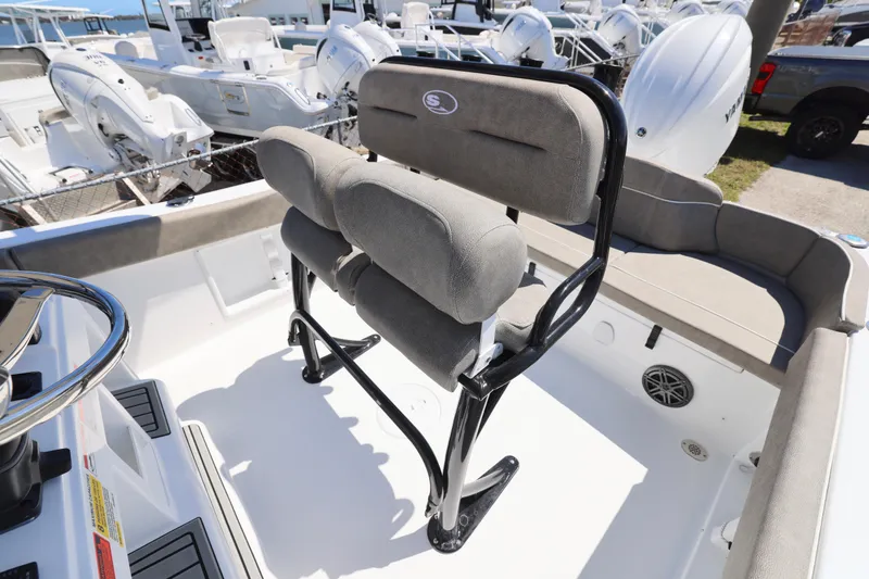 Slide: The Image of 2026 Sea Hunt Ultra 219 boat interior with cushioned seating and steering wheel. - 9