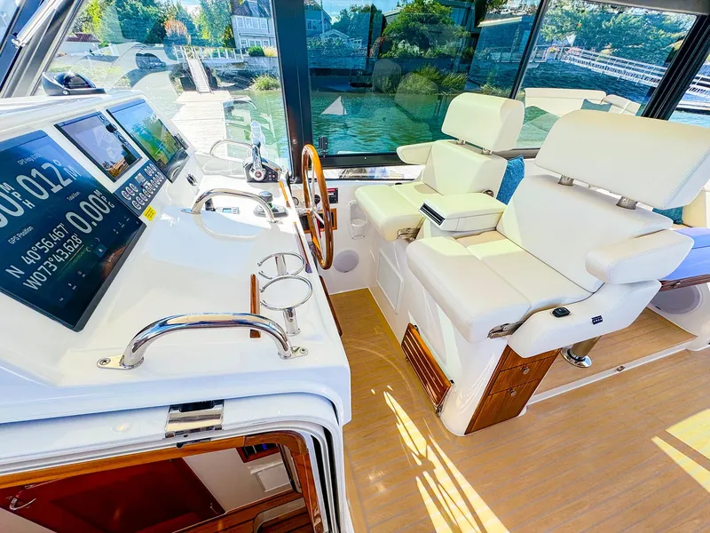 Slide: The Image of Luxurious 2024 MJM 4 yacht interior with modern helm and plush seating. - 15