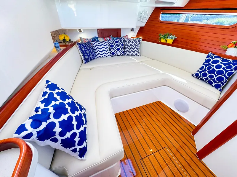 Slide: The Image of Luxurious 2024 MJM 4 yacht interior with elegant seating and vibrant blue-patterned cushions. - 38