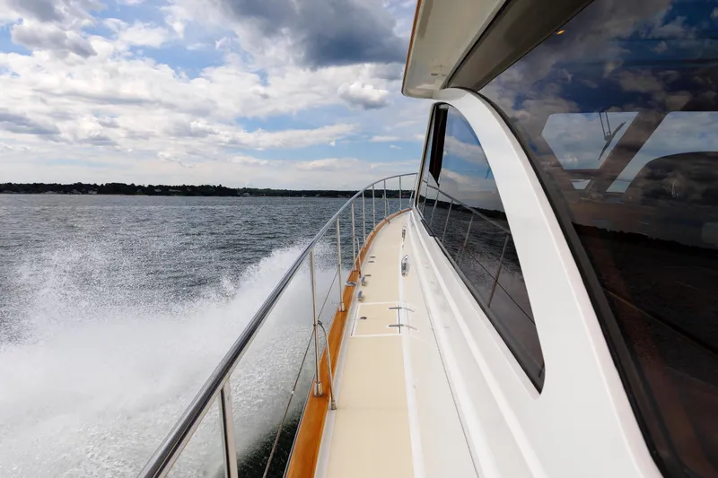 Slide: The Image of 2009 Hunt Yachts 52 Express cruising on open water under a cloudy sky. - 14