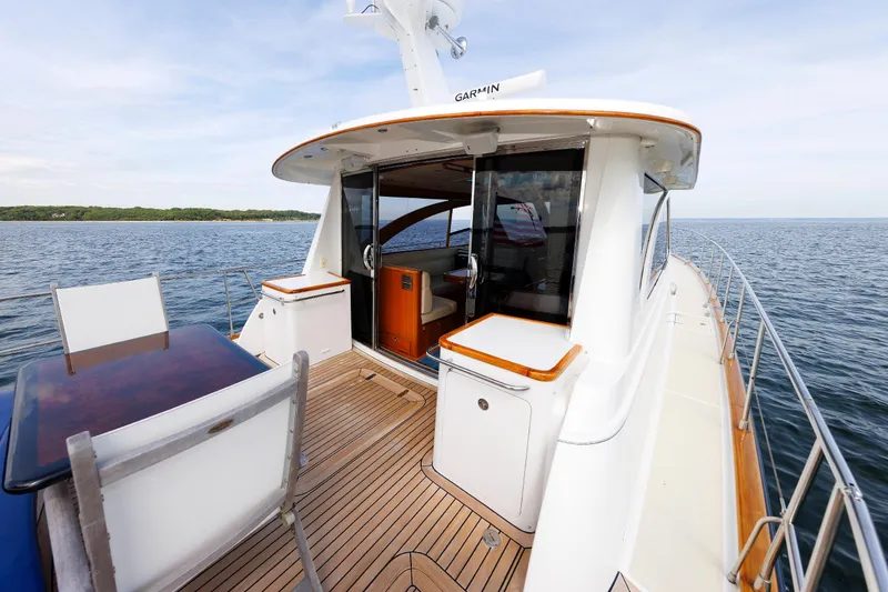 Slide: The Image of 2009 Hunt Yachts 52 Express on open water, featuring elegant deck and seating area. - 19