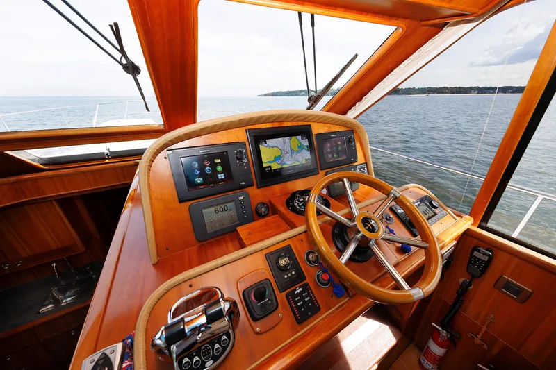 Slide: The Image of Helm of 2009 Hunt Yachts 52 Express with navigation screens and wooden steering wheel. - 31