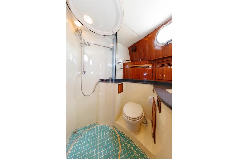 Slide: The Image of Luxurious bathroom in 2009 Hunt Yachts 52 Express, featuring shower and wooden cabinetry. - 40