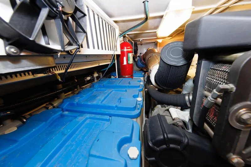 Slide: The Image of Engine room of 2009 Hunt Yachts 52 Express, featuring batteries and fire extinguisher. - 51