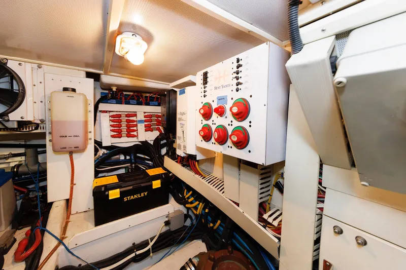 Slide: The Image of Engine room of 2009 Hunt Yachts 52 Express, featuring control panels and wiring. - 54
