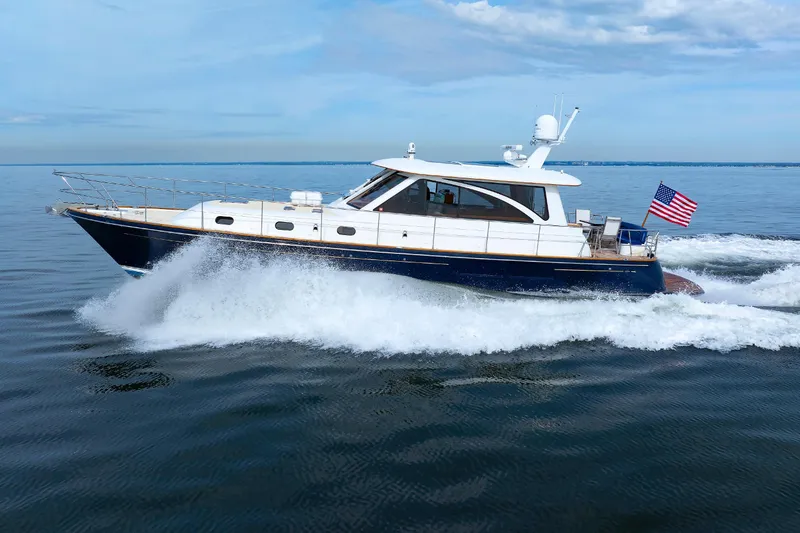 Slide: The Image of 2009 Hunt Yachts 52 Express cruising on open water with American flag. - 8