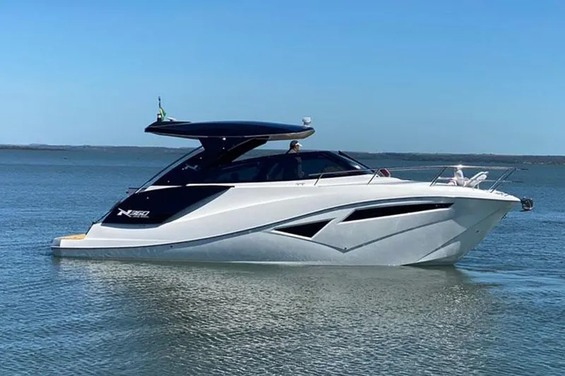 The Image of Manufacturer Provided Image: 2025 NX Boats 360 Sport Coupe on calm water, sleek design, modern luxury yacht. - 0