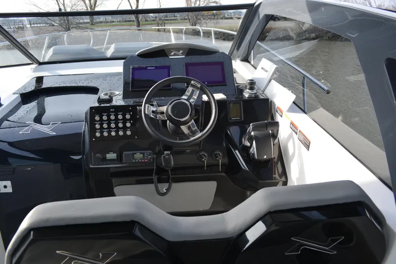 Slide: The Image of Interior cockpit of 2026 NX Boats 360 Sport Coupe, featuring modern controls and dual screens. - 10