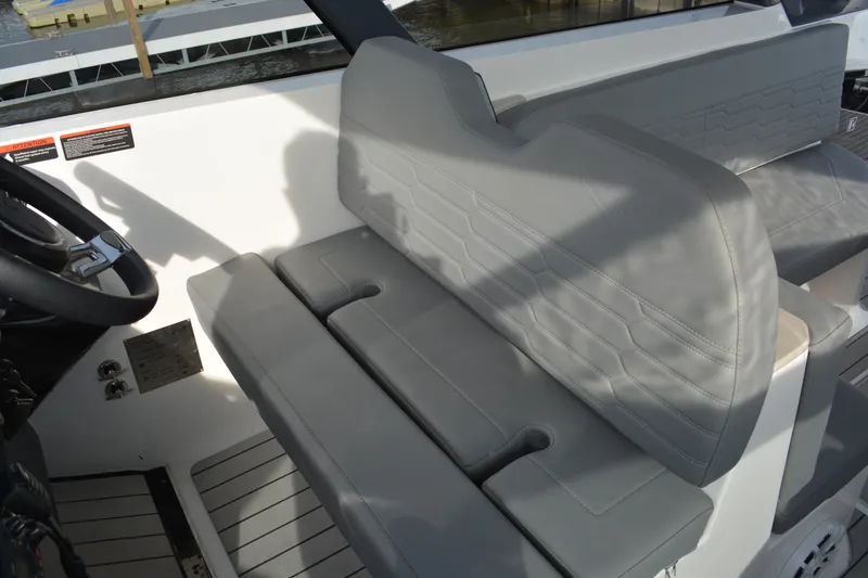 Slide: The Image of Interior seating of 2026 NX Boats 360 Sport Coupe, featuring sleek gray upholstery. - 11