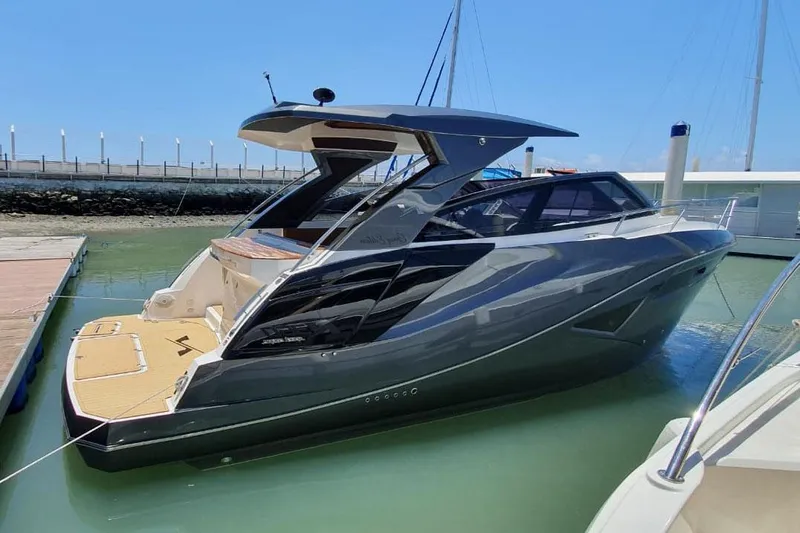 Slide: The Image of Manufacturer Provided Image: 2025 NX Boats 360 Sport Coupe docked in marina, sleek design, modern luxury yacht. - 2