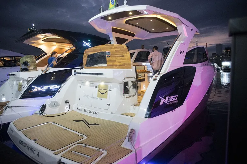 Slide: The Image of Manufacturer Provided Image: 2025 NX Boats 360 Sport Coupe docked at night, showcasing sleek design and illuminated features. - 4