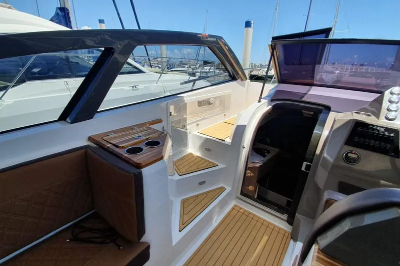 Slide: The Image of Manufacturer Provided Image: 2025 NX Boats 360 Sport Coupe interior with modern design and wood accents. - 7
