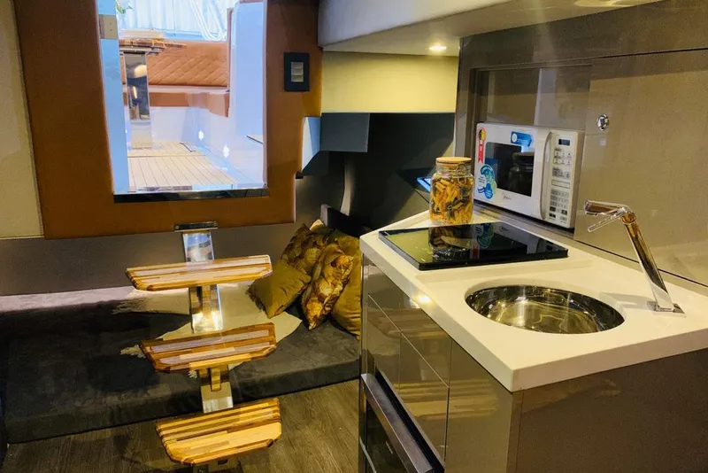 Slide: The Image of Manufacturer Provided Image: Interior of 2025 NX Boats 360 Sport Coupe, featuring modern kitchen and seating area. - 8