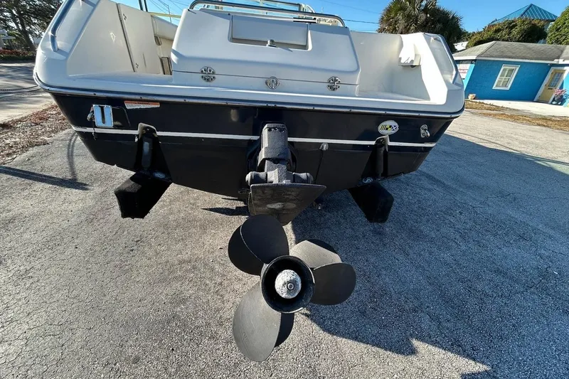 Slide: The Image of 2001 Pursuit 2460 Denali boat rear view with propeller on pavement. - 3