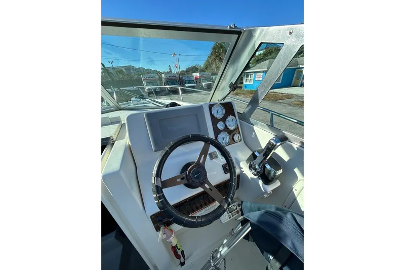 Slide: The Image of Helm of 2001 Pursuit 2460 Denali boat with steering wheel and gauges. - 7