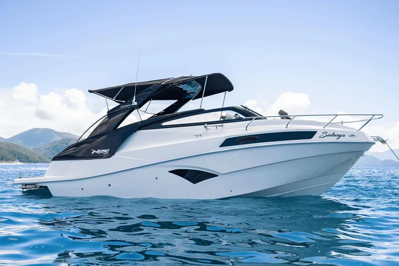 Slide: The Image of Manufacturer Provided Image: 2025 NX Boats 290 Exclusive cruising on clear blue water. - 2