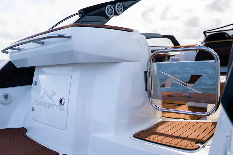 Slide: The Image of Manufacturer Provided Image: 2025 NX Boats 290 Exclusive, sleek design, open deck, luxury features, modern boating experience. - 6