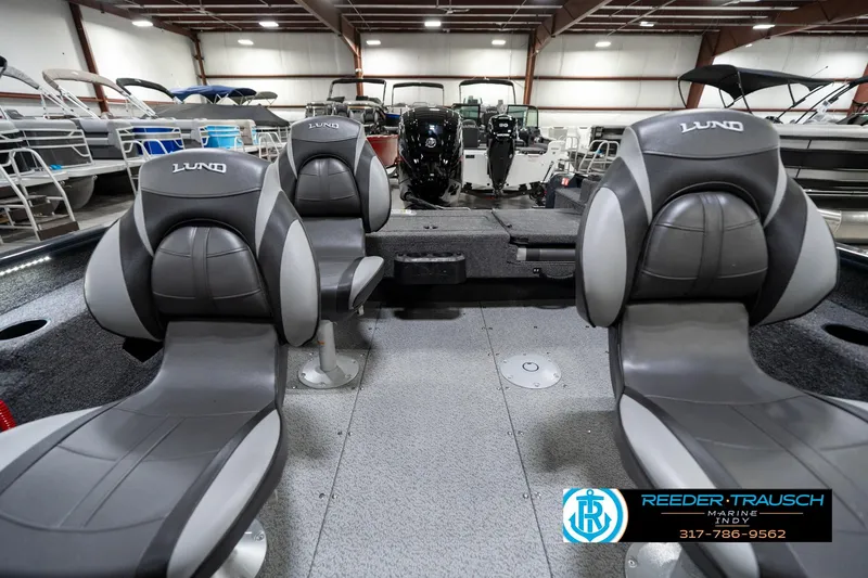 Slide: The Image of 2026 Lund 1775 Adventure SS boat interior with gray seating in showroom. - 17