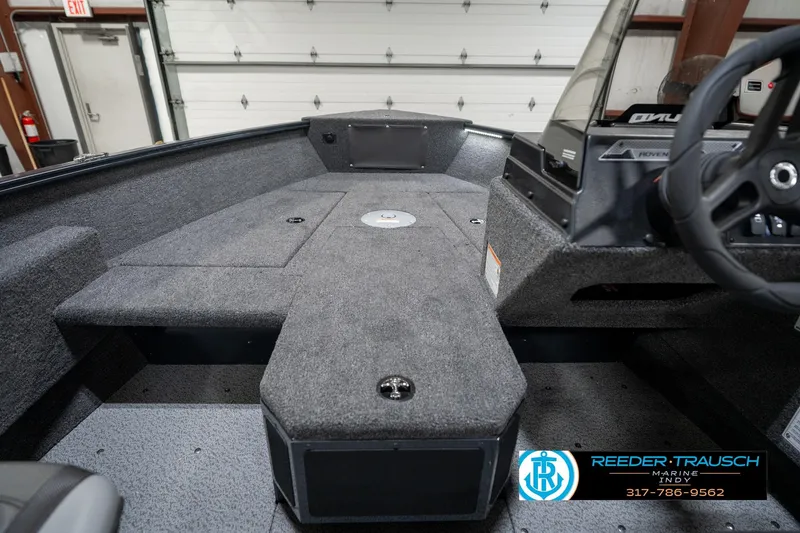 Slide: The Image of 2026 Lund 1775 Adventure SS boat interior with carpeted deck and steering console. - 26