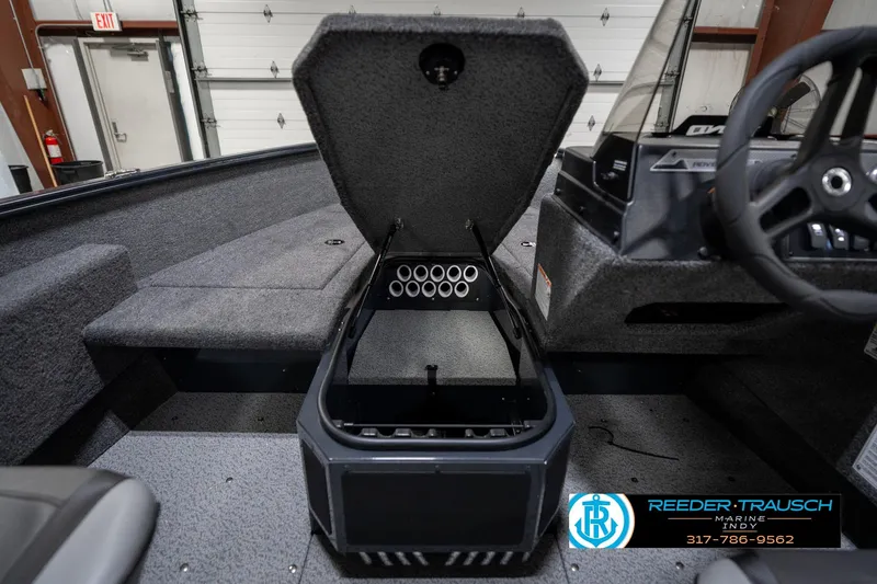 Slide: The Image of 2026 Lund 1775 Adventure SS boat interior with open storage compartment and steering wheel. - 27