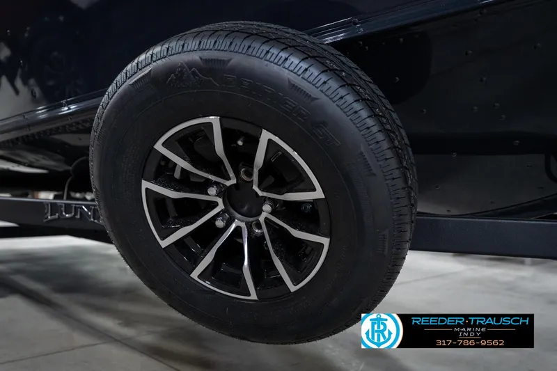 Slide: The Image of Close-up of a 2026 Lund 1775 Adventure SS trailer wheel with black and silver rim. - 59