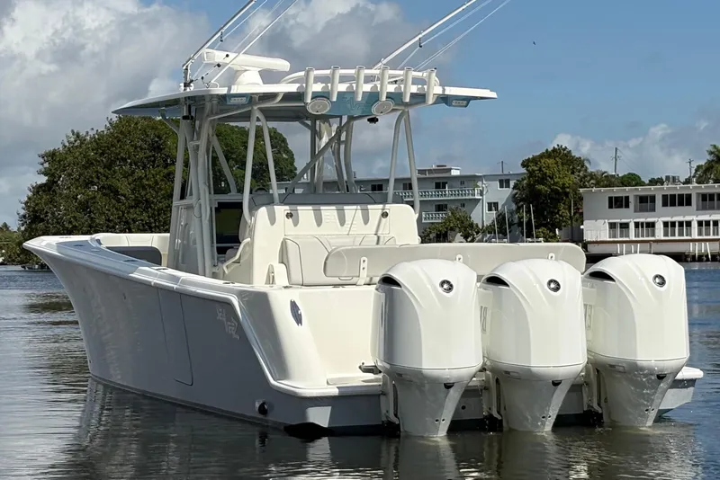 The Image of 2017 SeaVee 370Z boat with triple outboard engines on calm water. - 1