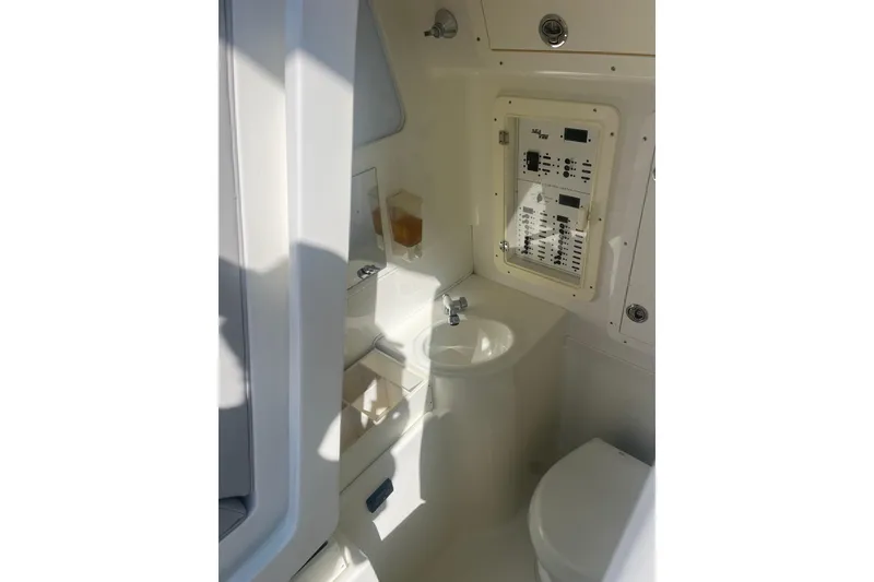 Slide: The Image of 2017 SeaVee 370Z boat interior with sink, control panel, and toilet. - 10