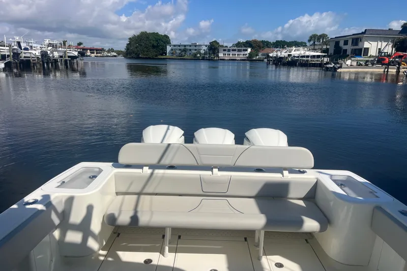 Slide: The Image of 2017 SeaVee 370Z boat with triple engines docked in a serene marina setting. - 15
