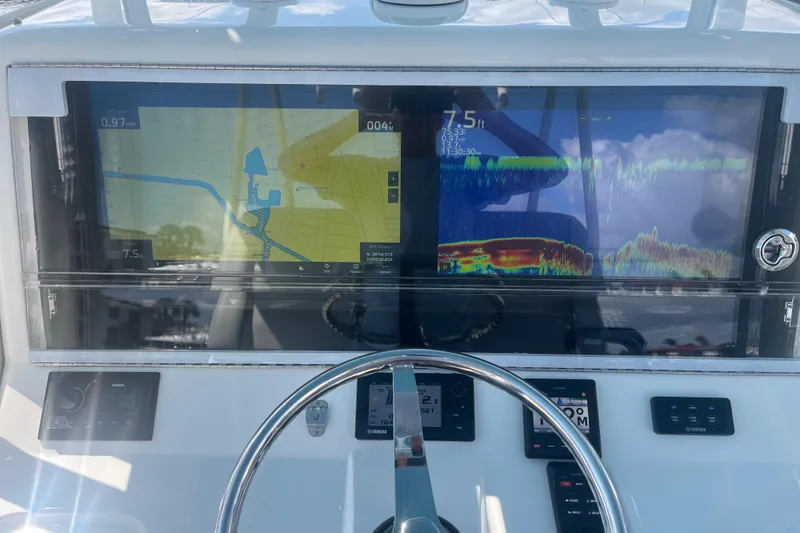 Slide: The Image of 2017 SeaVee 370Z boat dashboard with navigation and sonar displays. - 16