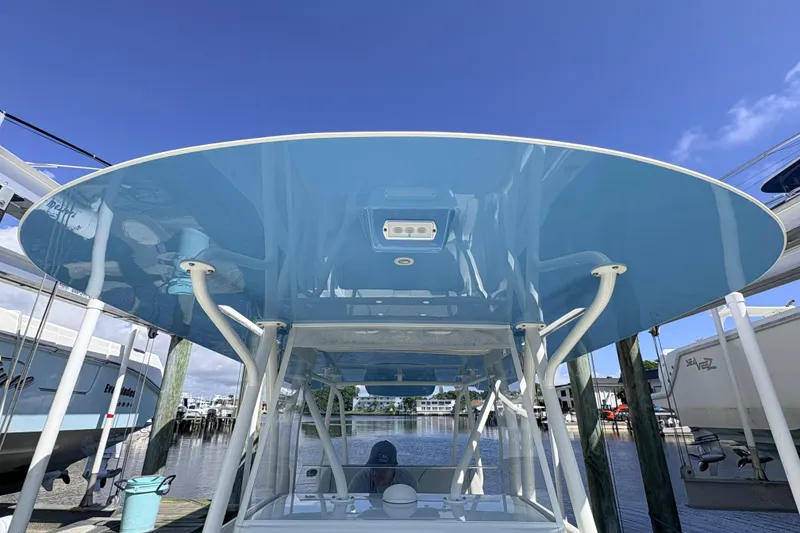 Slide: The Image of 2017 SeaVee 370Z boat with blue T-top at marina dock. - 20