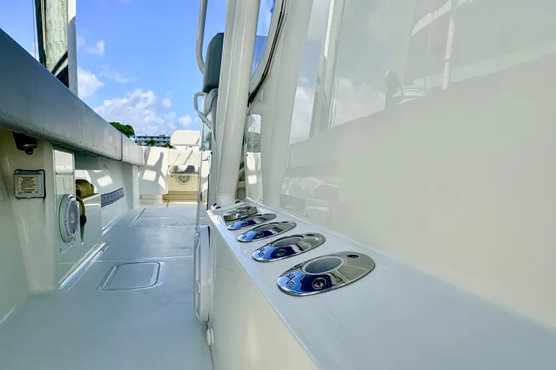 Slide: The Image of 2017 SeaVee 370Z boat deck with rod holders and clear sky background. - 21