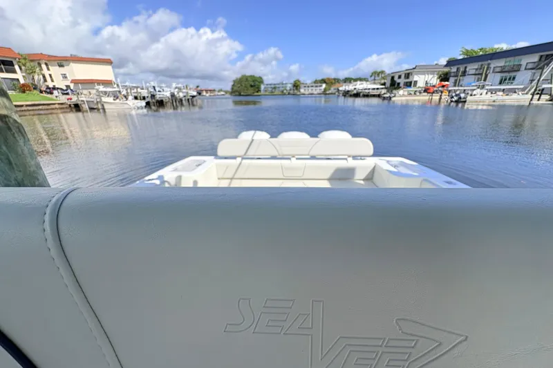 Slide: The Image of 2017 SeaVee 370Z boat docked in a scenic marina with clear skies. - 22