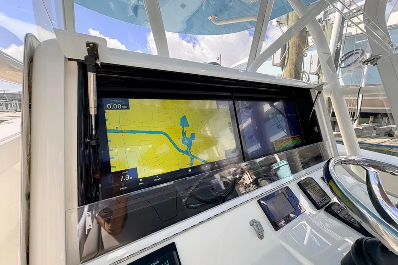 Slide: The Image of 2017 SeaVee 370Z boat dashboard with navigation and control displays. - 23