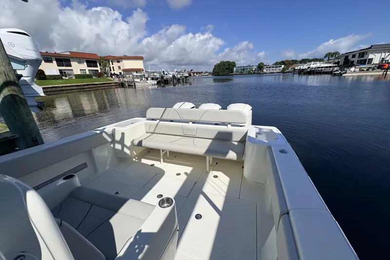 Slide: The Image of 2017 SeaVee 370Z boat interior with seating, docked by waterfront buildings. - 24