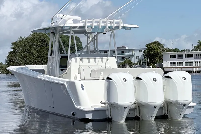 Slide: The Image of 2017 SeaVee 370Z boat with triple outboard engines on calm water. - 3